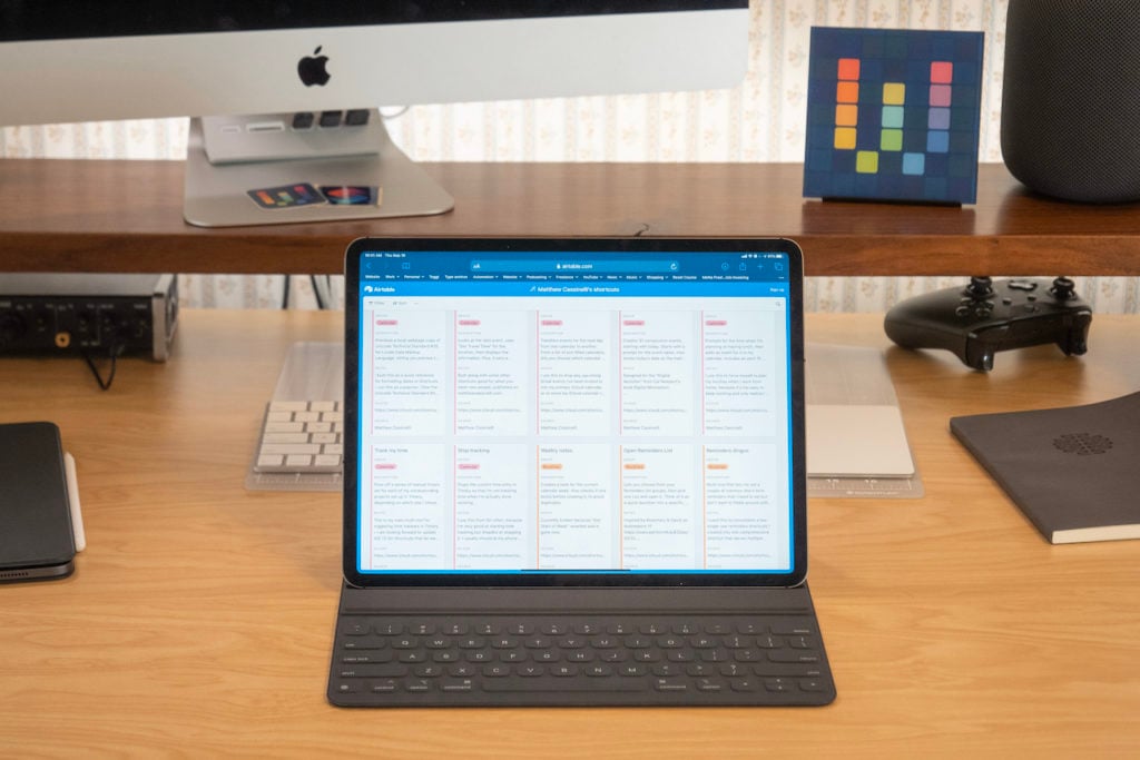 Photograph of Matthew Cassinelli's Shortcuts Library open on his iPad on his desk.